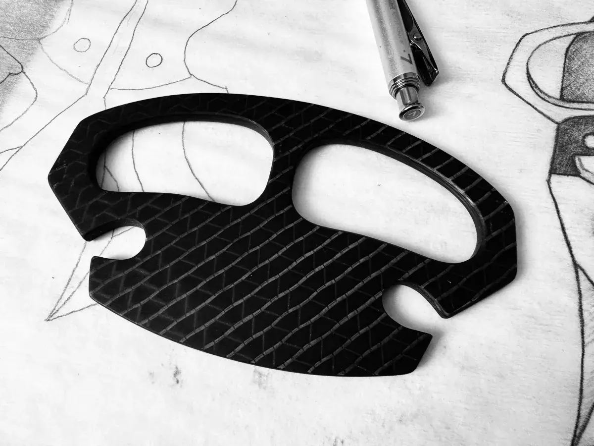 Knucklehead Labs Multi Tool displayed over Jonathan Harrington’s original drawings